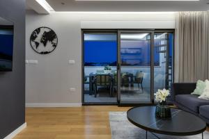 a living room with a couch and a table at Shell Sky Luxury Penthouse with Private Pool in Zadar