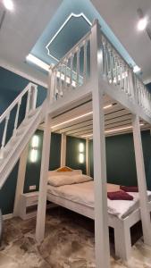 a bunk bed in a room with a staircase at Vinnytsia City Center Guest House in Vinnytsya +15 photos