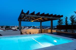 a swimming pool on the roof of a house at Shell Sky Luxury Penthouse with Private Pool in Zadar