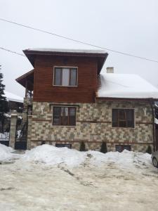 a brick house with snow in front of it at Complex Oazis in Etropole