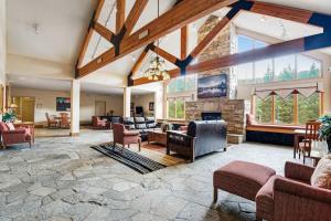 a large living room with a stone fireplace at Gateway #5055 in Keystone