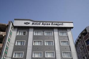 a building with a sign on the top of it at Hotel Asian Comfort in Srinagar