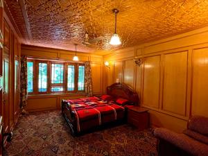 a bedroom with a bed and a coffered ceiling at Zakiyas Homestay in Srinagar