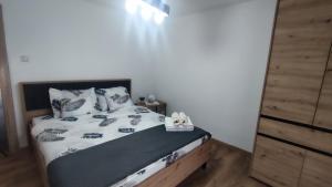 a bedroom with a bed with a black and white comforter at Konak Jugovo in Smederevo +10 photos