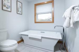 a white bathroom with a toilet and a sink at Maison Rouge by Simple Life Rentals in Luxemburg