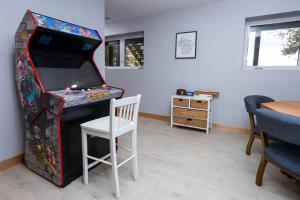 a white chair sitting next to a video game console at Maison Rouge by Simple Life Rentals in Luxemburg