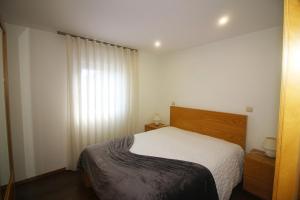 a small bedroom with a bed and a window at Paraíso do Gerês in Geres