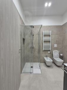 a bathroom with a shower and a toilet and a sink at Mirabaia in Bacoli +27 photos