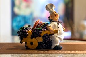 a figurine of a chef with a basket of grapes at El Balcón del Sol - Dpto Céntrico con Vistas Perfectas in Cusco +54 photos