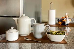 a counter top with tea pots and a bowl of food at El Balcón del Sol - Dpto Céntrico con Vistas Perfectas in Cusco