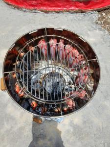 a grill with meat on top of it at Cabaña la fundadora in San Luis