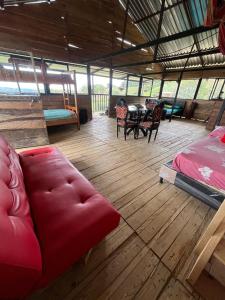 a living room with a red couch and a table at Cabaña la fundadora in San Luis +24 photos