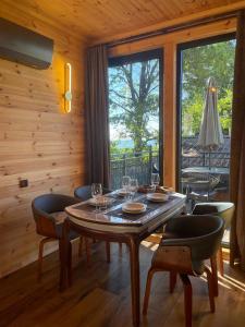 a wooden room with a table with wine glasses on it at GrapeHill Cottage in Achʼqva