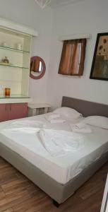 a white bed in a room with a kitchen at Mastic Point Studios in Chios