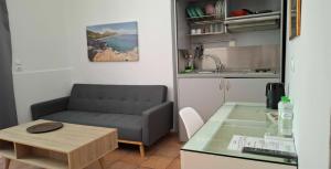 a living room with a couch and a table at Mastic Point Studios in Chios