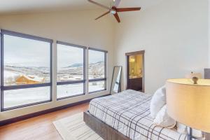 a bedroom with a bed and large windows at A Slice of Silverthorne in Silverthorne +87 photos
