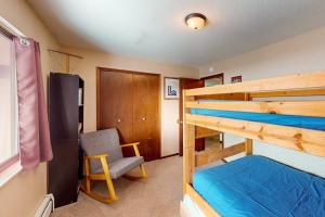 a bedroom with two bunk beds and a chair at Mountian View Condo Unit S303 in Dillon +41 photos