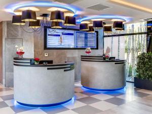 a lobby with a reception desk in a building at Novotel Orléans Saint Jean de Braye in Saint-Jean-de-Braye