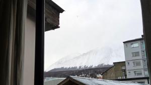 a view of a snow covered mountain from a window at Torre al Sur in Ushuaia