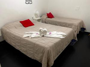 two beds in a room with towels on them at Hotel Astro in Mar del Plata +20 photos