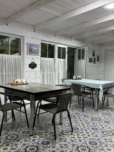 a room with two ping pong tables and chairs at Lisan VIllas in Nabran
