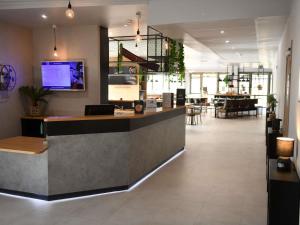 a lobby with a reception desk in a building at ibis Chateauroux in Châteauroux