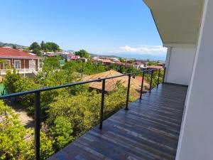 a balcony with a view of a city at Family Нotel Banuri in Kutaisi