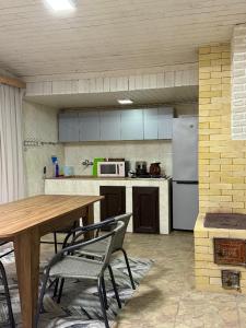 a kitchen with a table and chairs and a microwave at Lisan VIllas in Nabran +11 photos