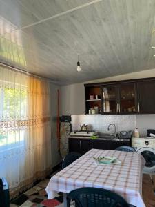a kitchen with a table and a sink at Liza's house - Block A in Ureki