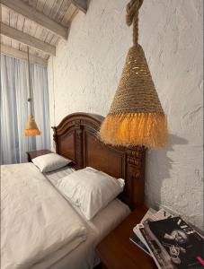 a bedroom with a bed and a chandelier at Lisan VIllas in Nabran