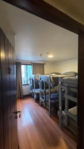a room with three bunk beds and a door at Torre al Sur in Ushuaia