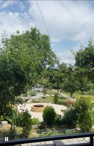 a garden with a park with trees and flowers at Near Yerevan Serlinhouse in Oshakan