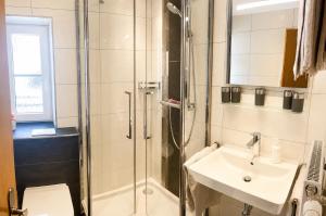 a bathroom with a shower and a sink and a toilet at Das Weber in Sankt Jakob in Defereggen