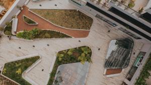 an overhead view of a building with plants on it at Wake Living in Medellín