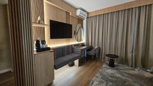 a hotel room with a desk and a television at Azuga Ski & Bike Resort in Azuga