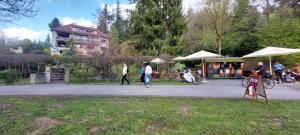 a group of people walking around a park with umbrellas at Apartmán U splavu Luhačovice in Luhačovice