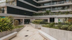 a building with a courtyard with plants in it at Wake Living in Medellín