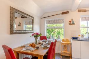 a dining room with a table and chairs and a mirror at 1 Bed in Filey oc-77710 in Hunmanby