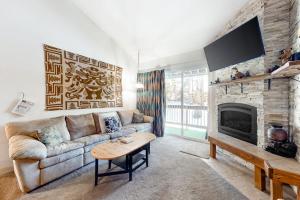 a living room with a couch and a fireplace at Crestview 36 in Mammoth Lakes