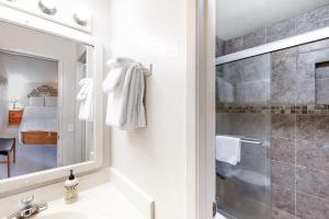 a bathroom with a shower and a sink and a mirror at Crestview 36 in Mammoth Lakes +89 photos