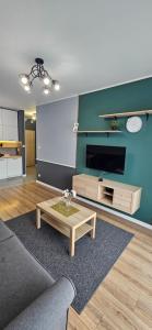 a living room with a couch and a coffee table at Andersena 43 Ząbki in Ząbki