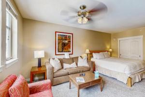 a living room with a bed and a couch at Founders Pointe Condo in Winter Park