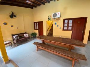 a room with a wooden bench and a staircase at Hospedagem De Ferias in Bonito