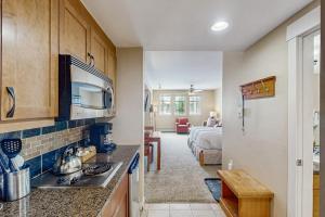 a kitchen and living room with a bed in a room at Founders Pointe Condo in Winter Park