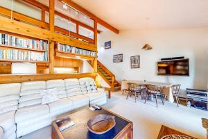 a living room with a white couch and a table at 3223 Thimbleberry in Wilson