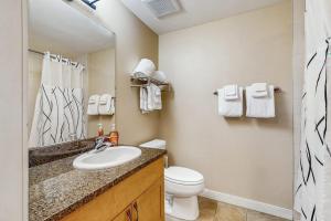 a bathroom with a sink and a toilet and a mirror at Founders Pointe Condo in Winter Park +83 photos