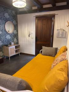 a bedroom with a large yellow bed and a table at Sale34 in Marsala