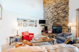 a living room with a stone wall at Marina Place 336 in Dillon