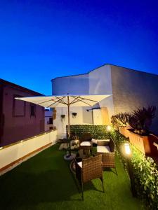 a patio with an umbrella and some chairs and tables at Sale34 in Marsala
