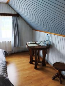 a table in the corner of a room with a bed at Motel KOKOS in Kosiv